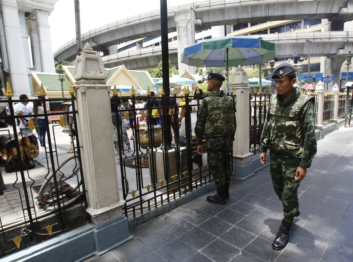 Thai soldiers walk outside the Erawan Shrine at Rajprasong intersection, the scene of last week's bombing, in Bangkok, Thailand, Monday, Aug. 24, 2015. (AP Photo/Sakchai Lalit)