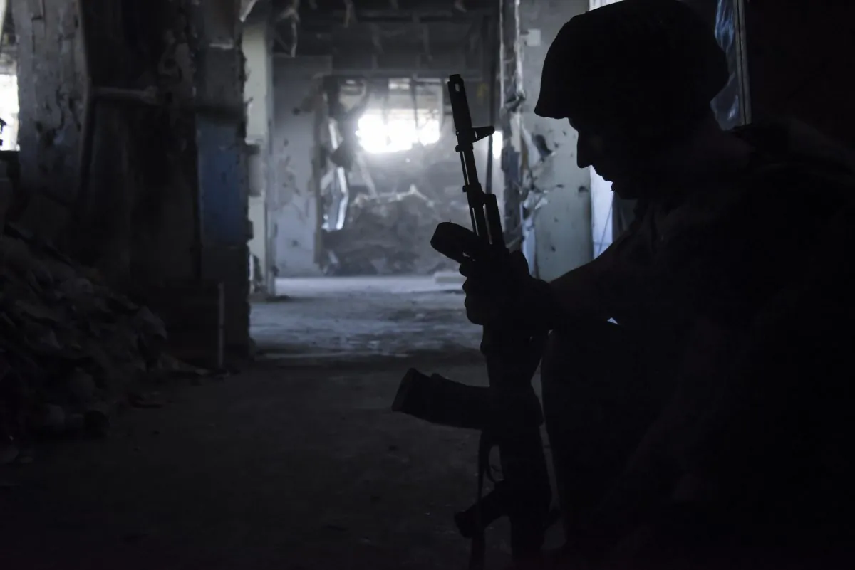A Russia-backed rebel prepares ammunition at his position inside Donetsk airport, Ukraine, on June 9, 2015. (Mstyslav Chernov/AP)