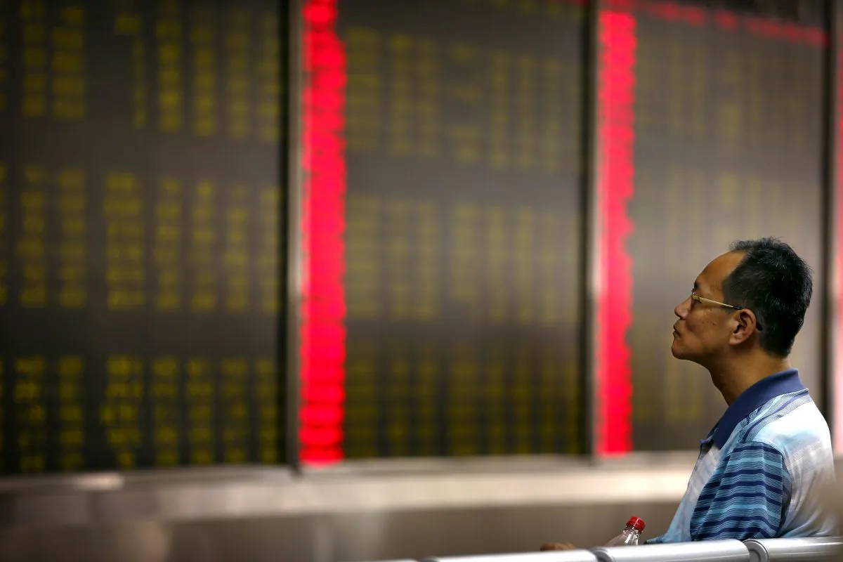 A Chinese investor monitors stock prices at  a brokerage house in Beijing, Monday, Aug. 24, 2015. Stocks tumbled across Asia on Monday as investors shaken by the sell-off last week on Wall Street unloaded shares in practically every sector. (AP Photo/Mark Schiefelbein)