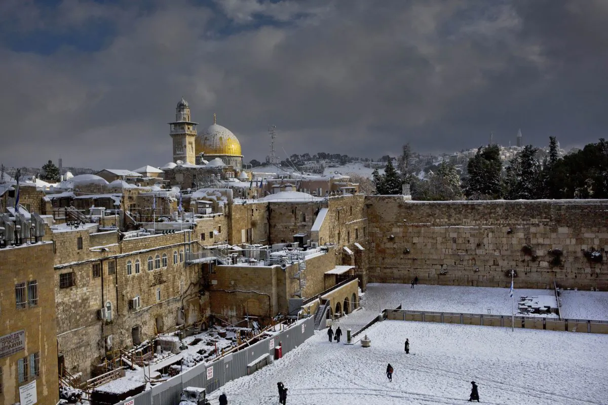 In this Friday, Dec. 13, 2013, file photo, the Western Wall and the Dome of the Rock, some of the holiest sites for for Jews and Muslims, are covered in snow in Jerusalem. (AP Photo/Dusan Vranic)