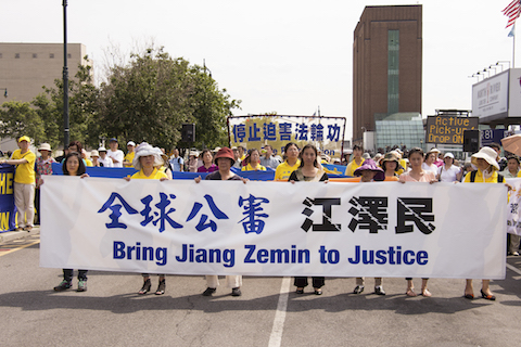 Falun Gong practitioners at a rally in front of the Chinese embassy in New York City on July 3, 2015, to support the global effort to sue Jiang Zemin. (Larry Dye/Epoch Times)