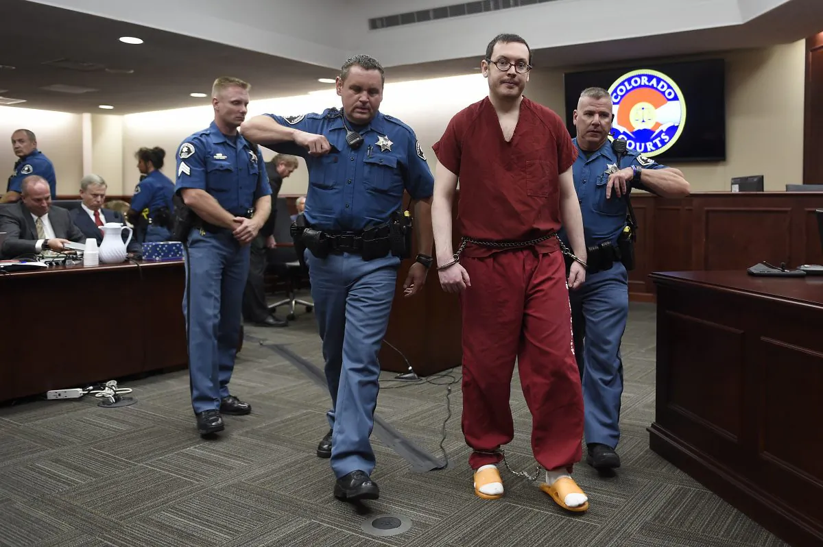 Colorado theater shooter James Holmes is led out of the courtroom after being formally sentenced on Wednesday, Aug. 26, 2015 in Centennial, Colo. (RJ Sangosti/The Denver Post via AP, Pool) 