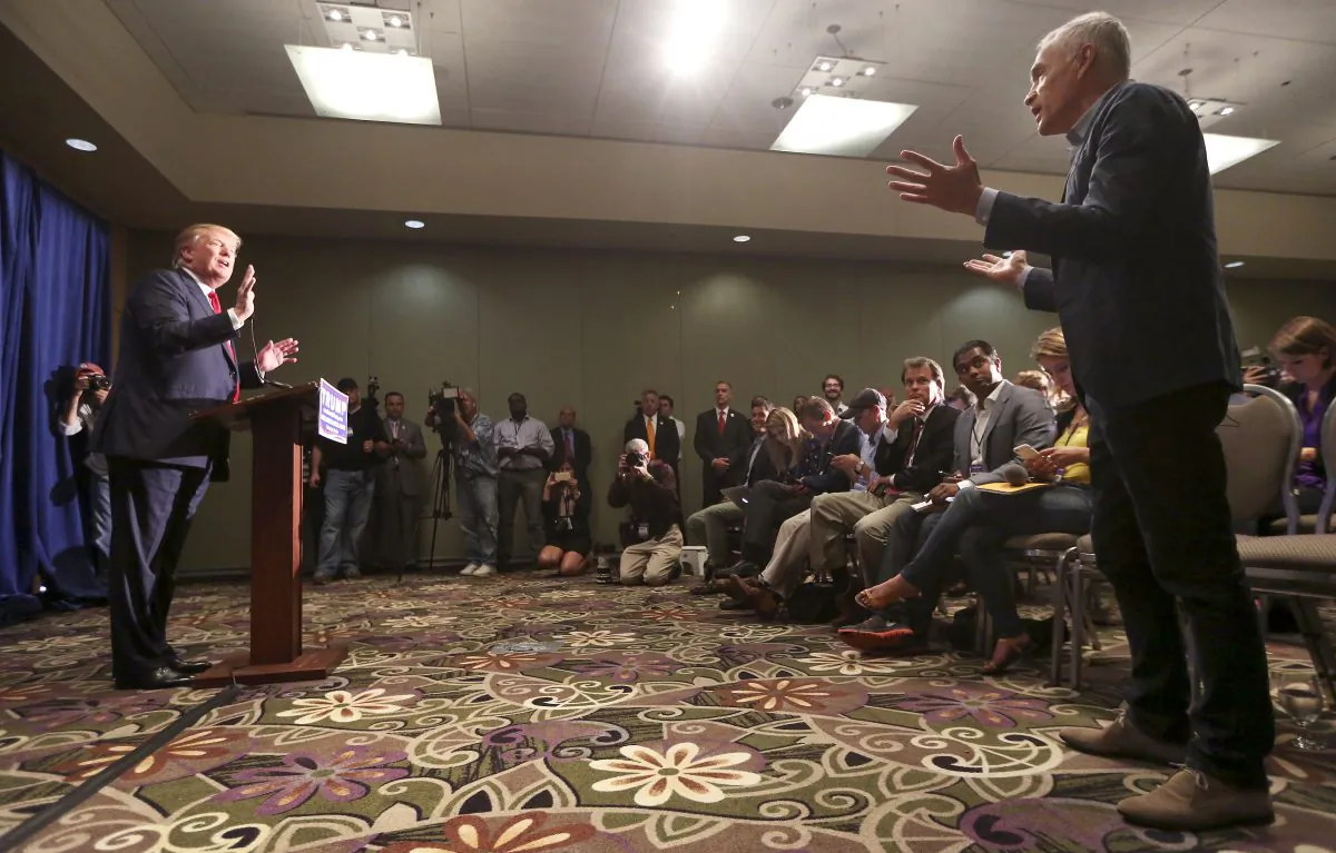 Univision journalist Jorge Ramos, right, asks Republican presidential candidate Donald Trump a question regarding immigration issues during a news conference on Tuesday, Aug. 25, 2015 in Dubuque, Iowa. (Nicki Kohl/Telegraph Herald via AP)