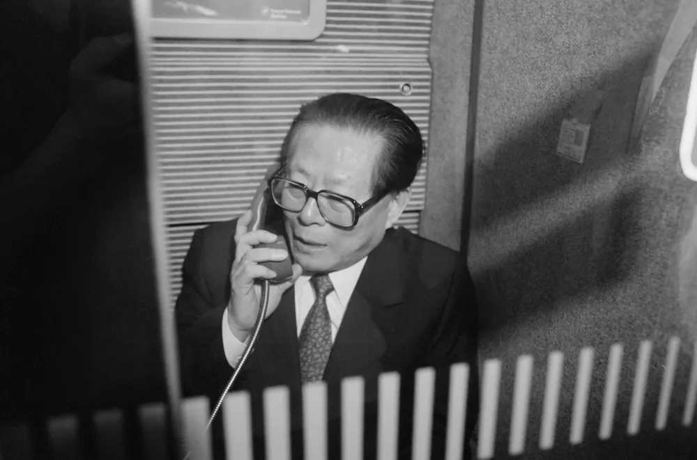 Leader of China, Jiang Zemin, stands in the phone booth of the TGV on his way to visit the nuclear center of Blayais. (Pierre Boussel/AFP/Getty Images)