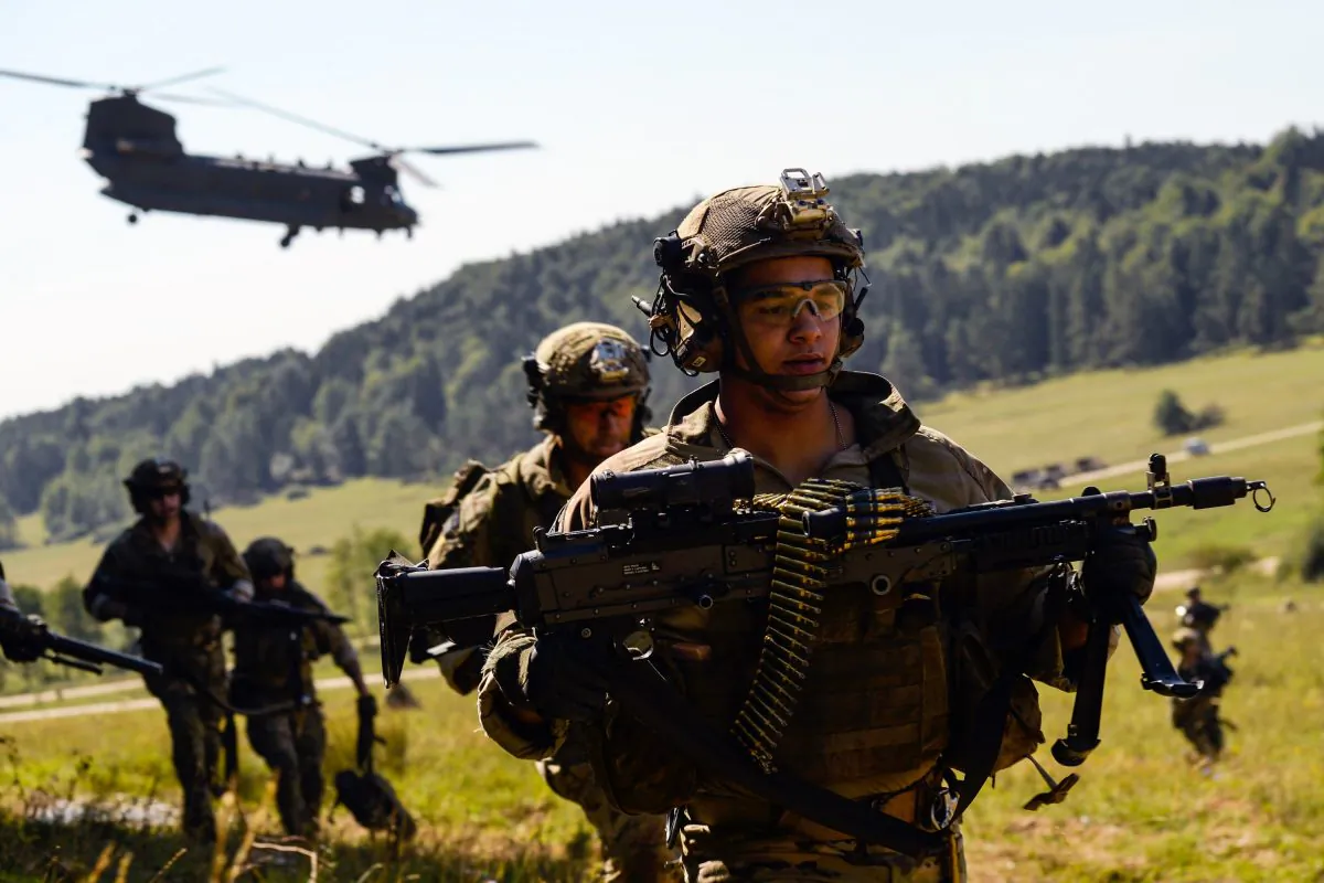 American special forces soldiers advance as a Chinook helicopter takes off during the "Swift Response" airborne training exercise in Hohenfels, southern Germany on Aug. 26, 2015. (Philipp Guelland/AFP/Getty Images)