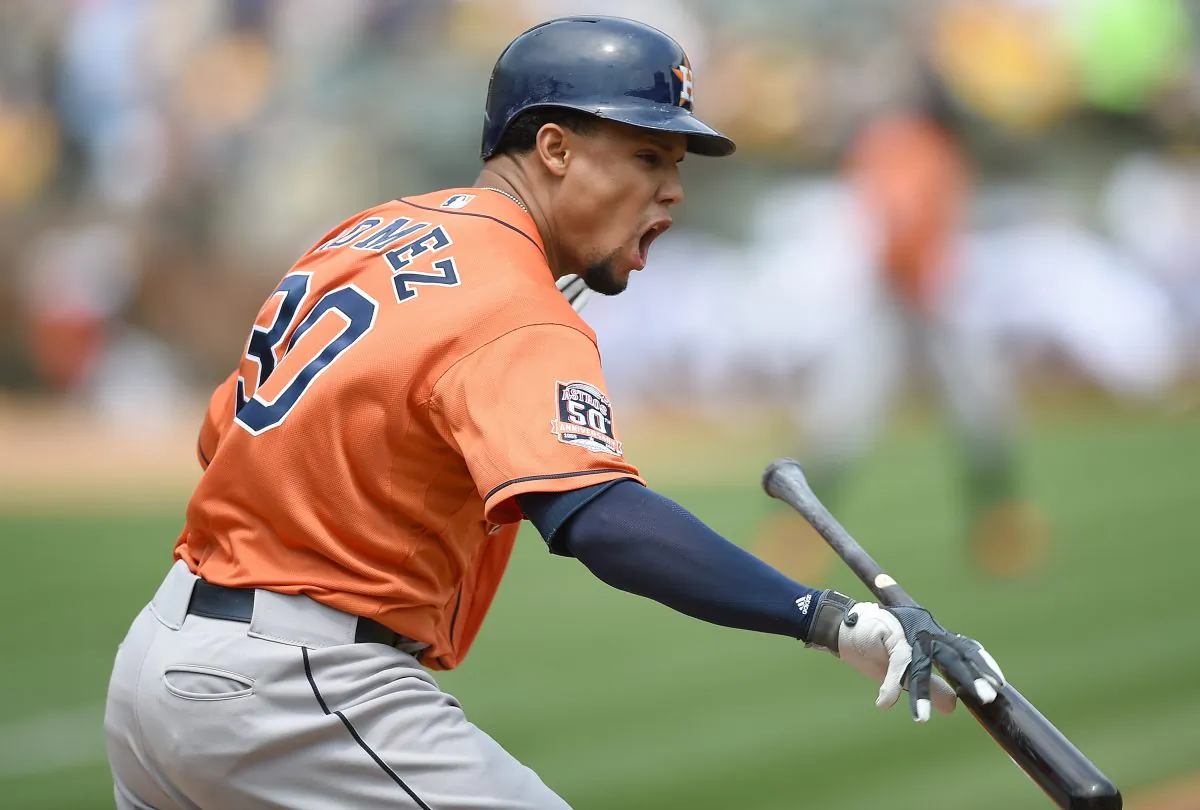 Carlos Gomez of the Houston Astros reacts and tosses his bat after he hits a fly ball for an out to right field against the Oakland Athletics. (Thearon W. Henderson/Getty Images)