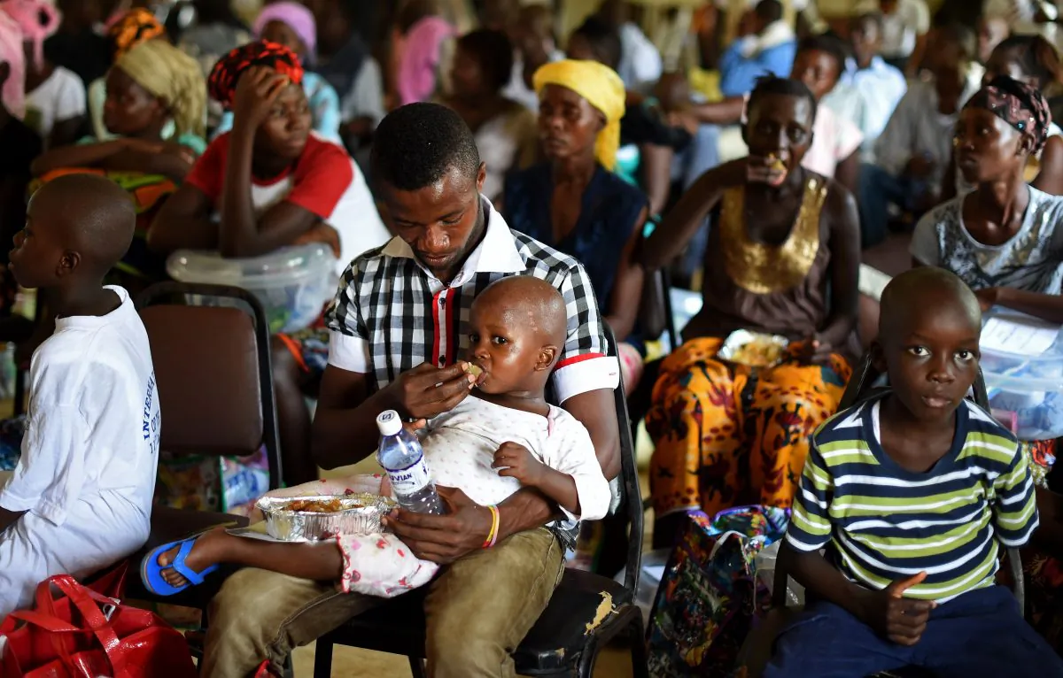 A child who survived the Ebola virus is fed by another survivor at Hastings Treatment Center, on the outskirts of Freetown, Sierra Leone, on Nov. 11, 2014. (Francisco Leong/AFP/Getty Images)