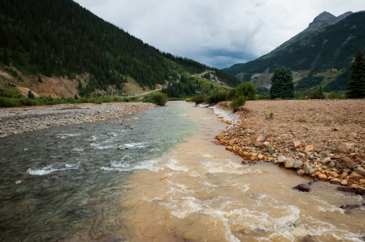 Cement Creek, which was flooded with millions of gallons of mining wastewater, meets with the Animas River in Silverton, Colorado, on Aug. 11, 2015. The Environmental Protection Agency accidentally released approximately three million gallons of wastewater into the creek from the Gold King Mine, polluting the larger Animas River downstream. (Theo Stroomer/Getty Images)