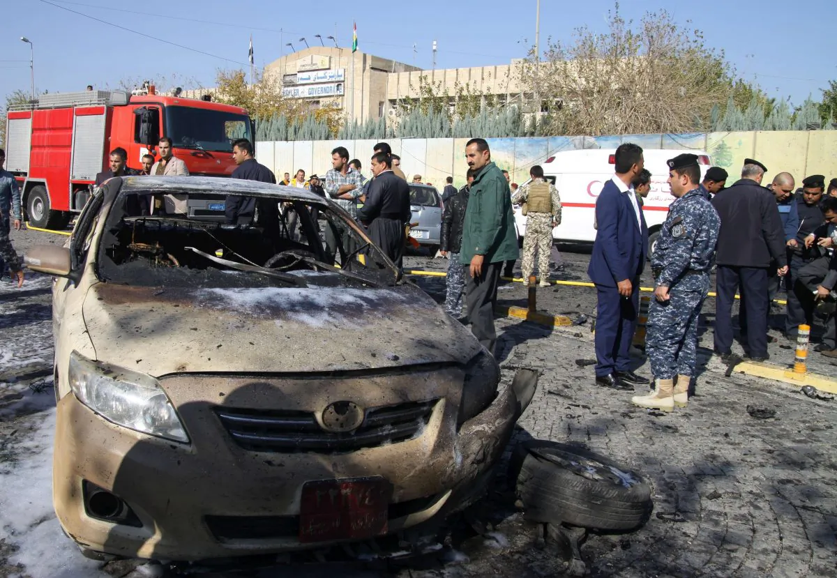 Iraqi security forces stand at the site where a suicide bomber detonated an explosives-rigged vehicle in the Iraqi Kurdish regional capital Arbil on November 19, 2014, killing four people. (AFP/Getty Images)