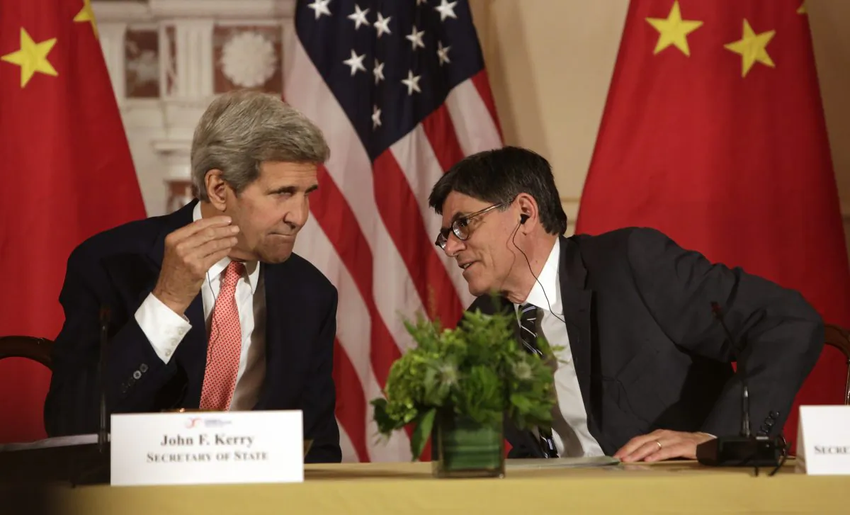 US Secretary of State John F. Kerry (L) confers with US Treasury Secretary Jacob Lew (R) during the closing session of the seventh US-China Strategic and Economic Dialogue (S&ED) at the US State Department in Washington DC, June 24, 2015. (Chris Kleponis/AFP/Getty Images)