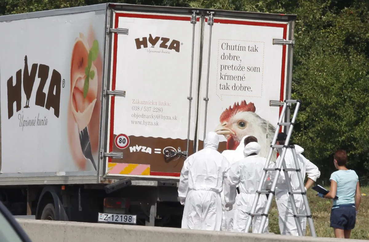 Forensic officers in front of a truck inside which were found a large number of dead migrants on a motorway near Neusiedl am See, Austria, on Thursday, Aug. 27, 2015. (Dieter Nagl/AFP/Getty Images)