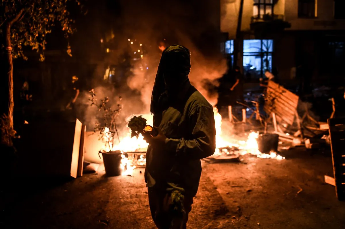 A masked kurdish militant holds a molotov cocktails in front of a barricade during clashes with Turkish police on Aug. 27,2015, in the Gazi district of Istanbul. Five people, including two children and a soldier, were killed in clashes between Kurdish militants and security forces in Turkey's restive Kurdish-majority southeast on Aug. 27, 2015, local officials and the army said. (Ozan Kose/AFP/Getty Images)
