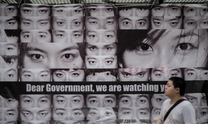 Posters showing pictures of the eyes of pro-democracy protesters are displayed in the Admiralty district of Hong Kong on Nov 11, 2014. (Philippe Lopez/AFP/Getty Images)