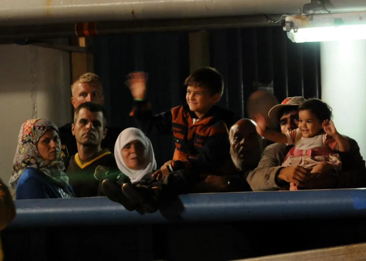 Migrants wait to disembark from Swedish ship Poseidon at the Palermo harbor, Italy, Thursday, Aug. 27, 2015. (AP Photo/Alessandro Fucarini)