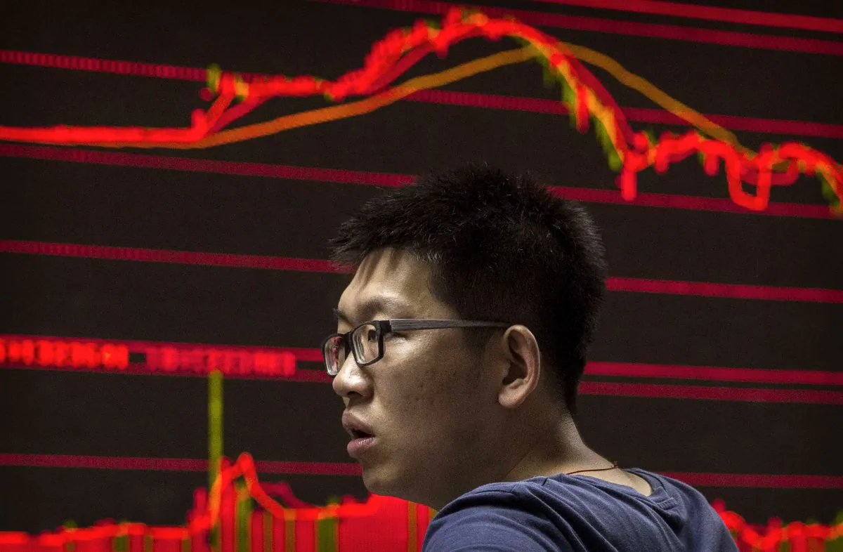 A Chinese day trader reacts as he watches a stock ticker at a local brokerage house on August 27, 2015 in Beijing, China. (Kevin Frayer/Getty Images)
