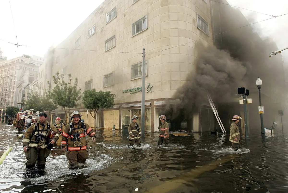 Firefighters arrive at a store on fire on Canal Street August 31, 2005 in New Orleans, Louisiana. Devastation is widespread throughout the city with water approximately 12 feet high in some areas. (Mark Wilson/Getty Images)