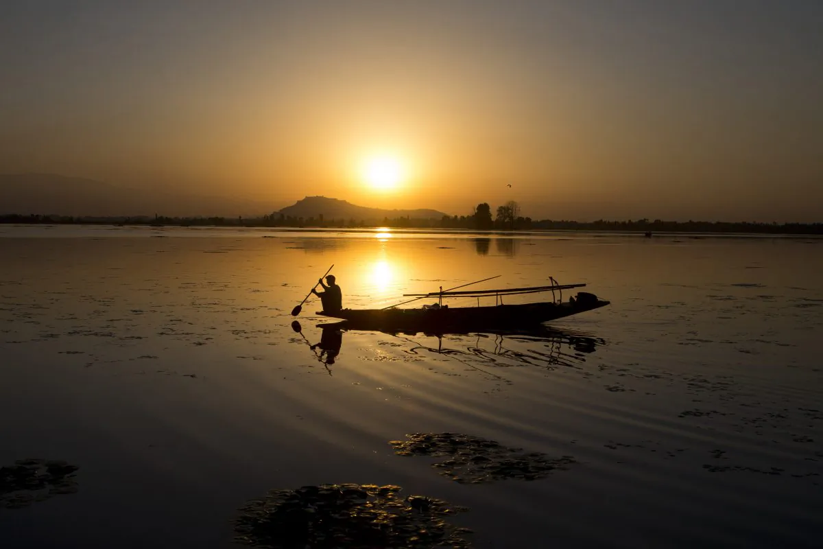A Kashmiri fisherman rows his Shikara, or traditional boat, during sunset at the Dal Lake in Srinagar, Indian controlled Kashmir, on Aug. 29, 2015. (Dar Yasin/AP Photo)