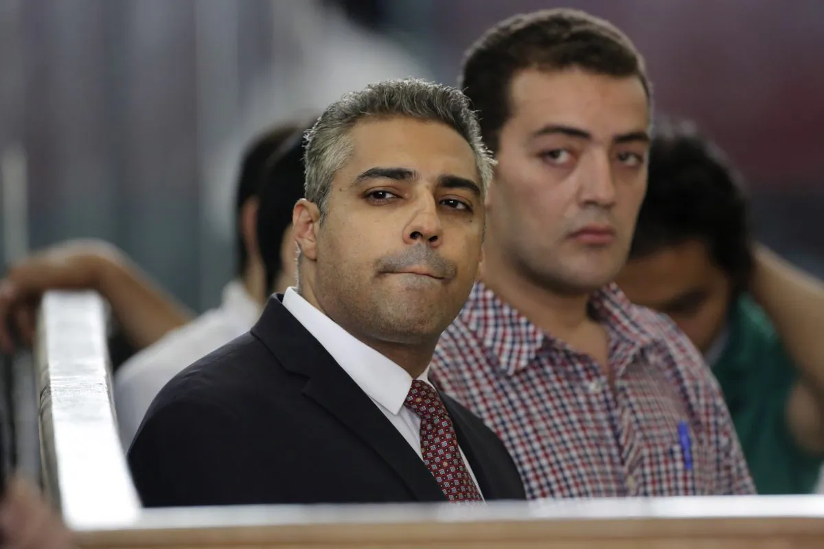 In this Thursday, June 4, 2015 file photo, Canadian Al-Jazeera English journalist Mohammed Fahmy, left, and his Egyptian colleague Baher Mohammed listen in a courtroom in Tora prison in Cairo, Egypt. (AP Photo/Amr Nabil)