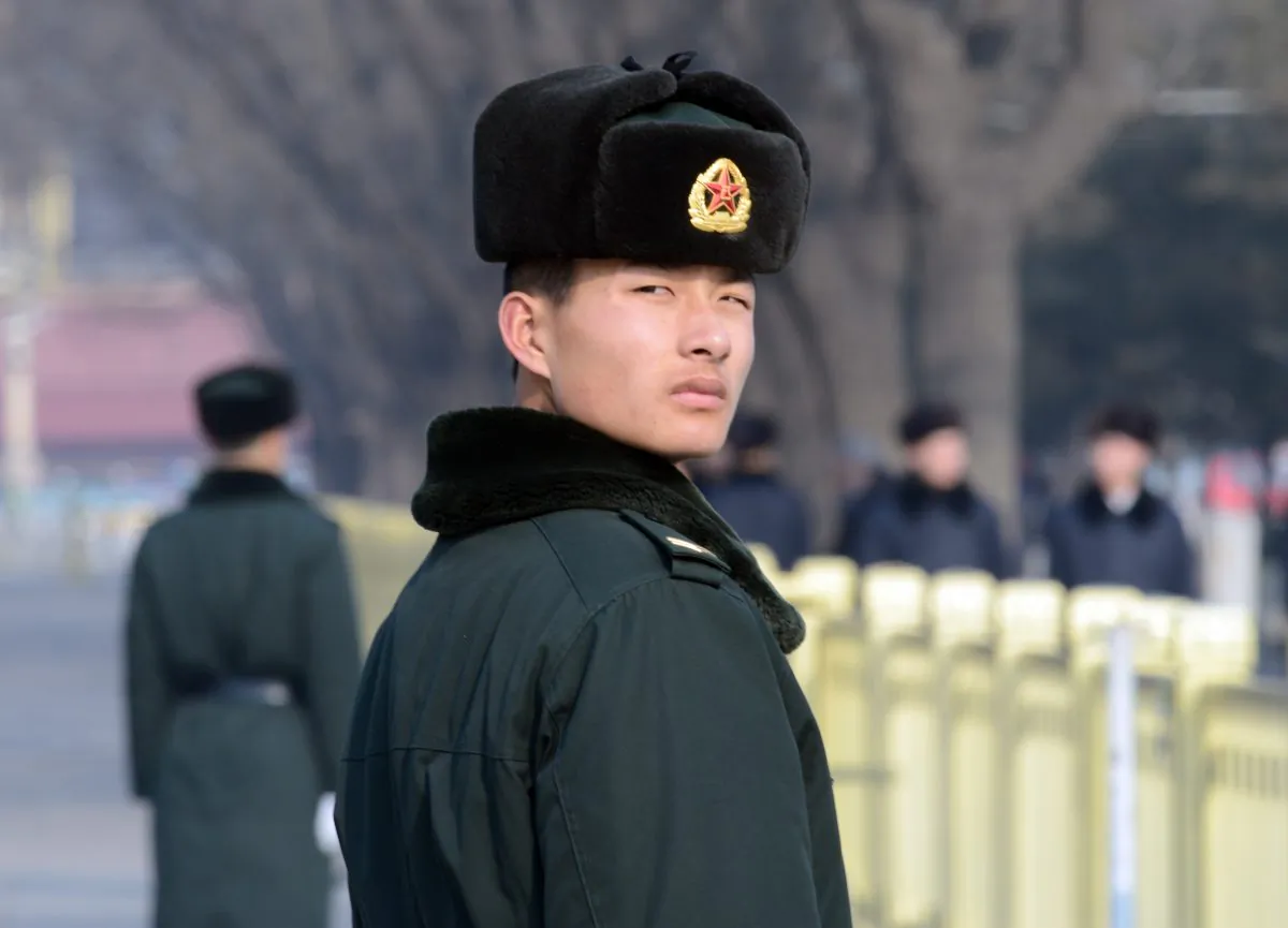 A Chinese paramilitary policeman keeps an eye on visitors to Tiananmen Square in Beijing on Jan. 27, 2014. Authorities recently punished nearly 200 Internet users for expressing themselves online. (Goh Chai Hin/AFP/Getty Images)
