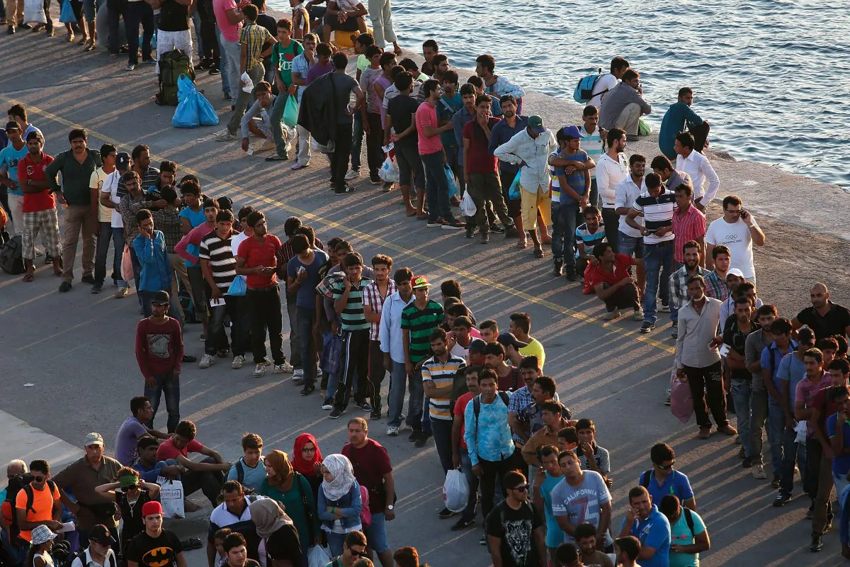 Migrants wait to board a ferry from the island of Kos, Greece, for transport to the Greek mainland port of Piraeus on Monday, Aug. 31, 2015. (Win McNamee/Getty Images)