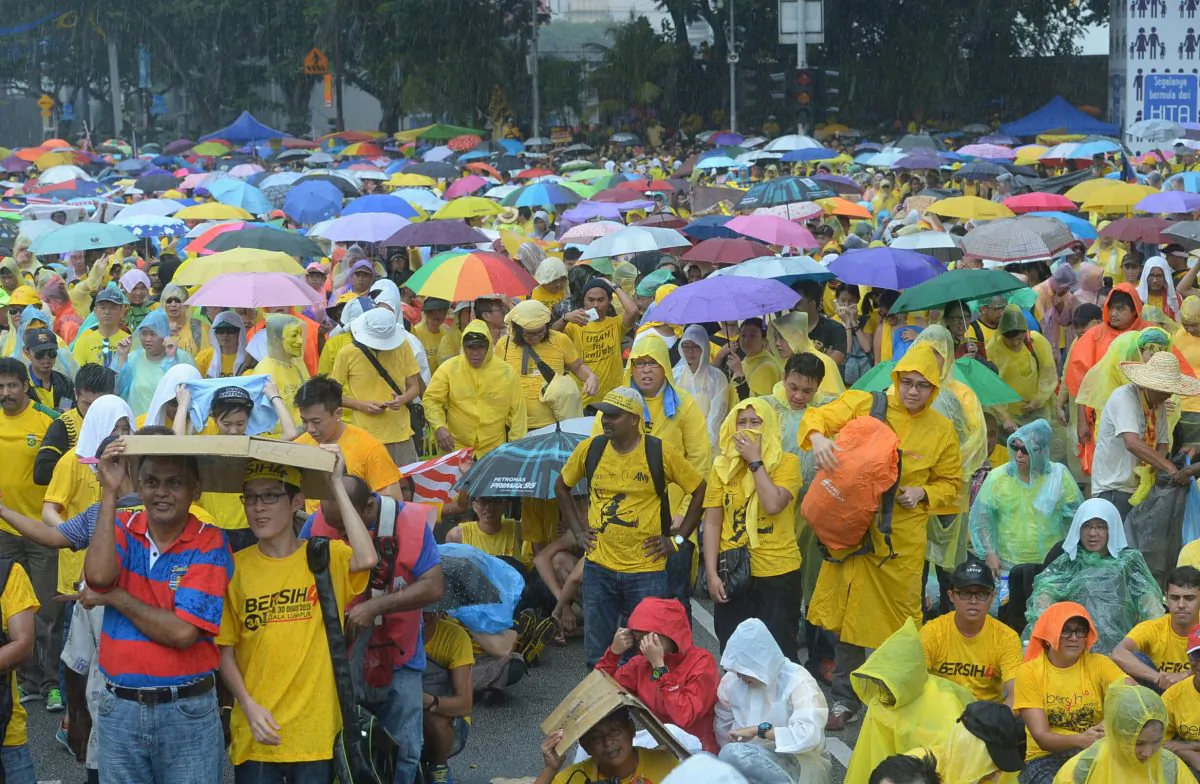 Malaysian protesters gather in the rain during a rally in Kuala Lumpur, Malaysia on Sunday, Aug. 30, 2015. (AP Photo)