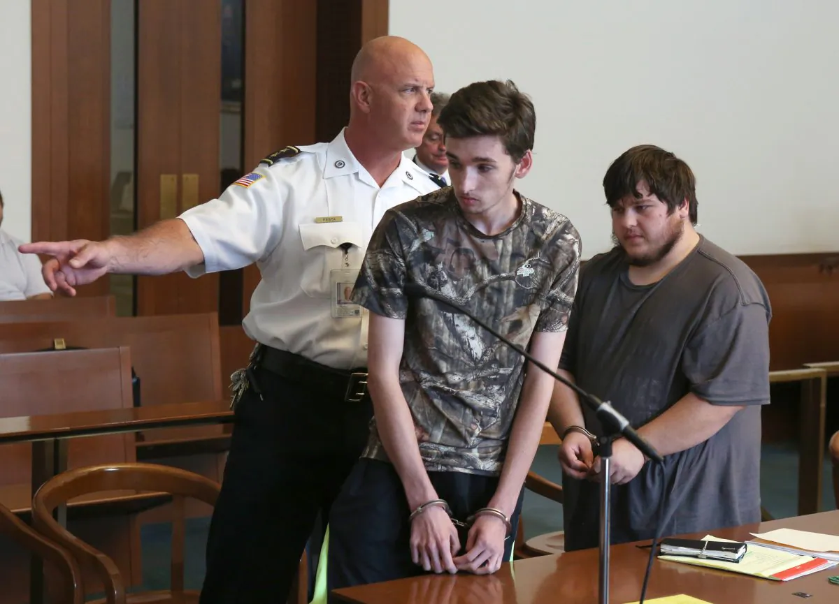 Kevin Norton and James Stumbo leave the courtroom following their dangerousness hearing at Boston Municipal Court, Tuesday, Sept. 1, 2015. The Iowa men, accused of making online threats of violence against the World Pokemon Championships competition in Boston, were ordered held without bail Tuesday after Judge Thomas Horgan rejected arguments by their lawyers that their comments amounted to idle online bravado. (Angela Rowlings/The Boston Herald via AP, Pool)