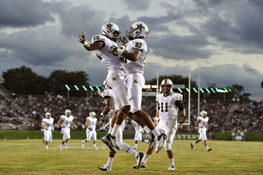 Vanderbilt's Chris Boyd (80) chest bumps Jordan Matthews (87) after Matthews' touchdown against Northwestern during the first half of an NCAA college football game Saturday, Sept. 8, 2012, in Evanston, Ill. (AP Photo/Jim Prisching)