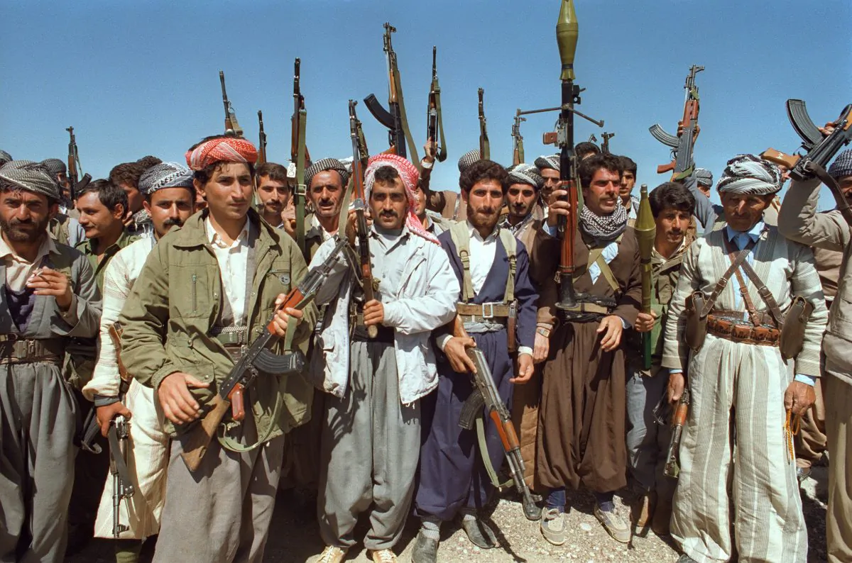 Several Kurdish Peshmerga fighters brandish their arms near Salaheddine, Iraq, on March 27, 1991. (Ramzi Haidar/AFP/Getty Images)