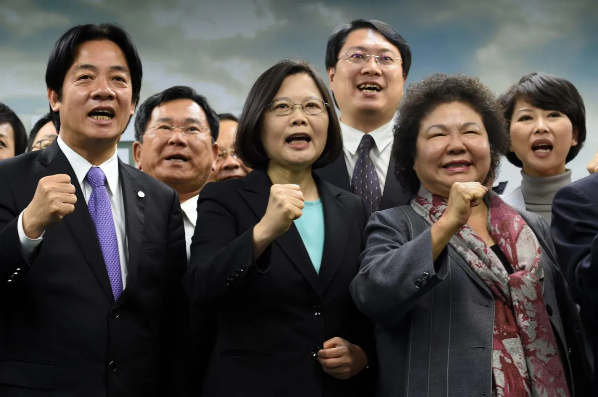 Tsai Ing-wen (C), chairwoman of Taiwan's main opposition Democratic Progressive Party (DPP), gestures with party members during a press conference in Taipei on April 15. The Chinese regime is holding military drills simulating invasions of Taiwan, ahead of the Taiwanese presidential elections. (SAM YEH/AFP/Getty Images)