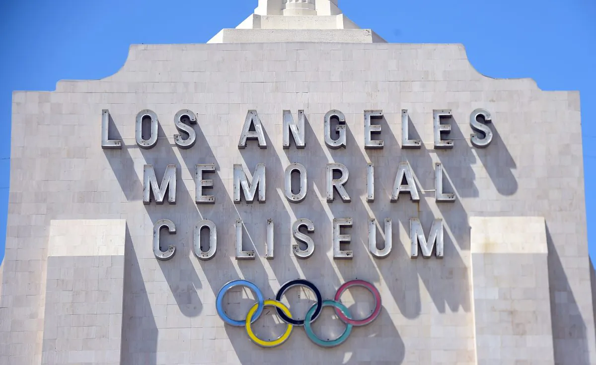 A worker manouevers is vehicle past an entrance to the Los Angeles Coliseum, which played host to the 1932 and 1984 Summer Olympics, in Los Angeles, California on August 31, 2015. (Frederic J. Brown /AFP/Getty Images)