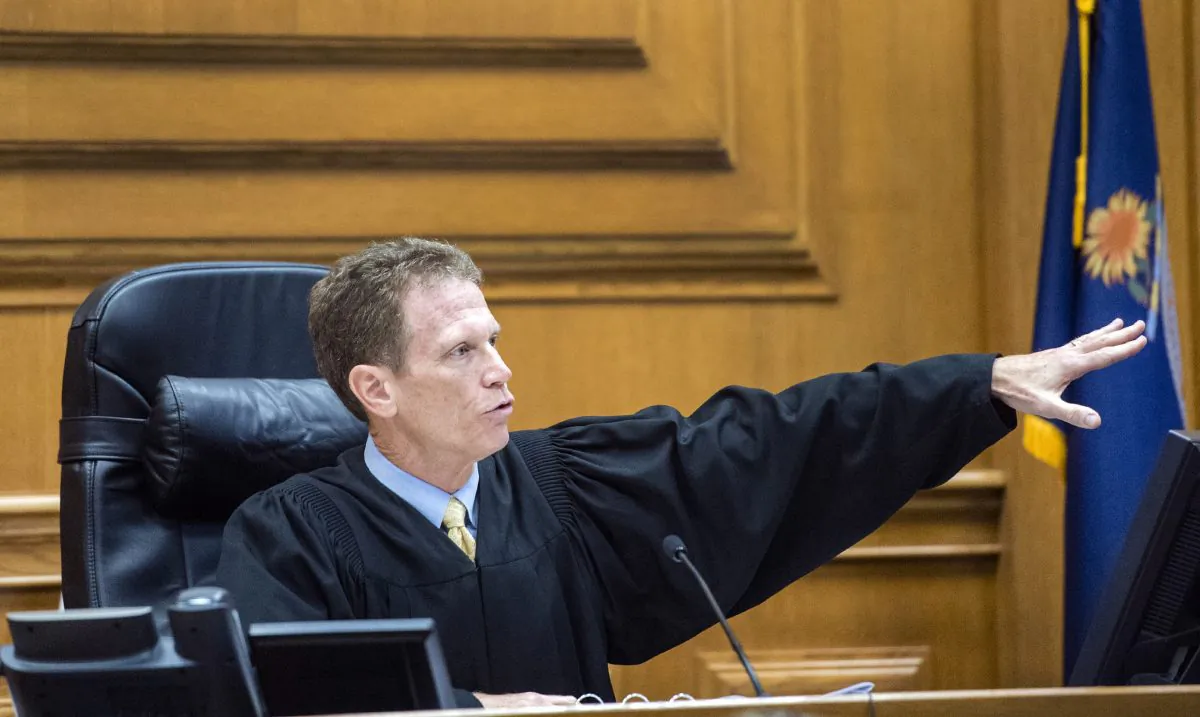 District Court Judge Kelly Ryan admonishes Frazier Glenn Miller for his courtroom behavior after Miller after was found guilty of one count of capital murder, three counts of attempted murder and assault and weapons charges on Monday, Aug. 31, 2015, in the Johnson County Courthouse in Olathe, Kan. (Allison Long/The Kansas City Star via AP)