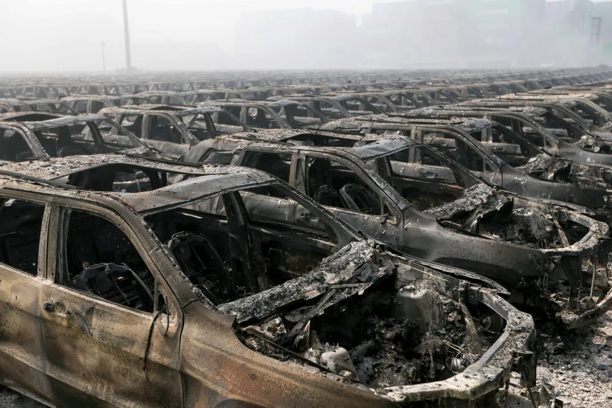 Brand new cars parked in Tianjin port are seen badly damaged at the site of the massive explosions in Tianjin on Aug. 13, 2015. (STR/AFP/Getty Images)