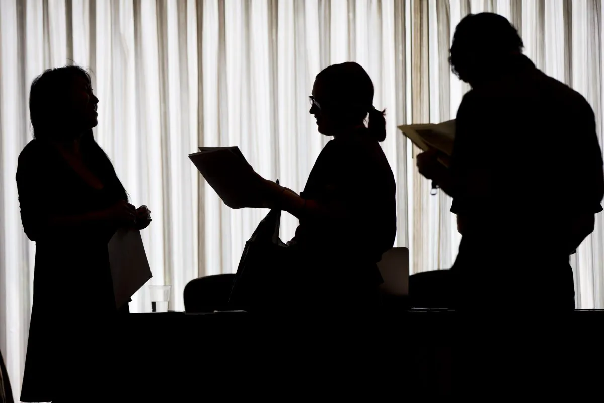 Recruiter Christina O. (L), with New Western Acquisitions, meets with employment seekers during a job fair in Philadelphia, on June 23, 2014. (Matt Rourke/AP)