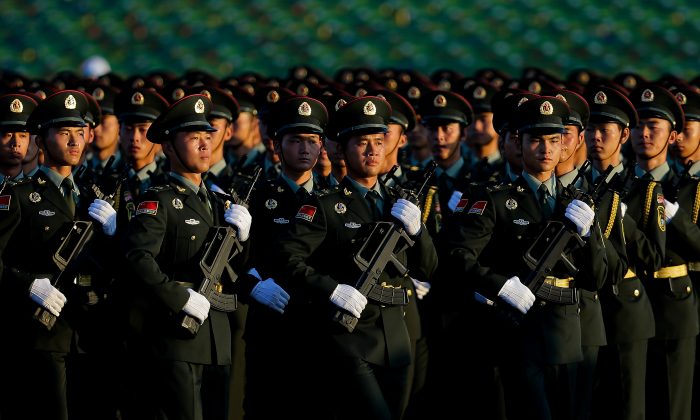 Chinese People's Liberation Army troops practice marching as they arrive at Tiananmen Gate for a military parade to commemorate the 70th anniversary of the end of the World War II in Beijing Thursday Sept. 3, 2015. (AP Photo/Andy Wong)