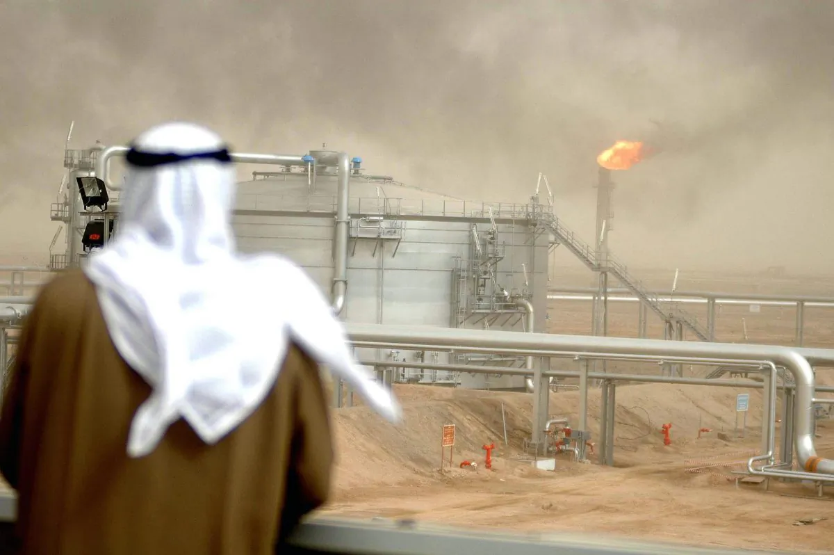 An employee of the Kuwait Oil Company (KOC) looks at a Gathering Center 15 of al-Rawdatain field, 62 miles north of Kuwait City, on Jan. 25, 2005. (Yasser al-Zayyat/AFP/Getty Images)