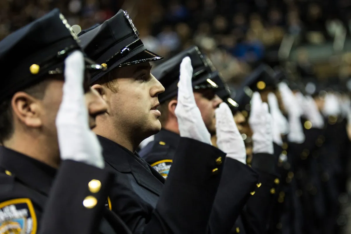 Police officers recite an oath during a NYPD graduation ceremony at Madison Square Garden, in New York City, on Dec. 29, 2014. (Andrew Burton/Getty Images)