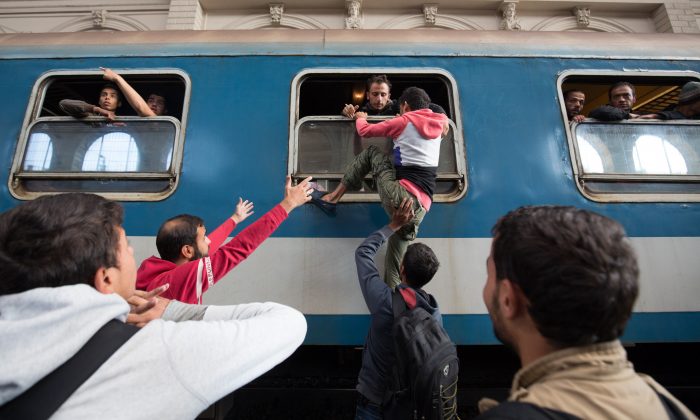Migrants board trains in Keleti station after it was reopened this morning in central Budapest on September 3, 2015 in Budapest, Hungary. (Matt Cardy/Getty Images)