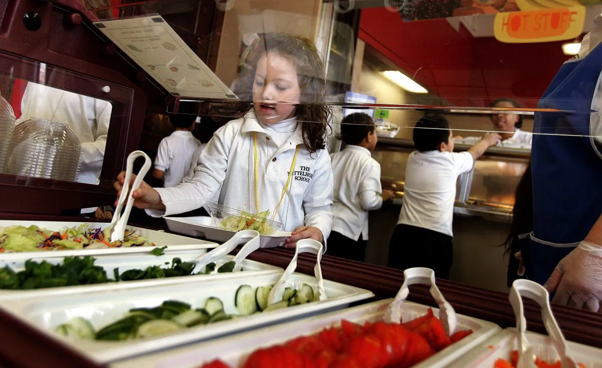 CHICAGO - MARCH 20:  Nettelhorst Elementary School student, Alexia Kollar, selects food from a salad bar during lunch March 20, 2006 in Chicago, Illinois. U.S. Senator Dick Durbin (D-IL) stopped by the school to visit the new pilot lunch program called, "Cool Foods," part of the Healthy Schools Campaign. Nettelhorst is one of three Chicago public schools participating in the new lunch program offering salad bars as a new federal law, effective June 30, 2006, states that all schools must establish wellness policies.  (Photo by Tim Boyle/Getty Images)