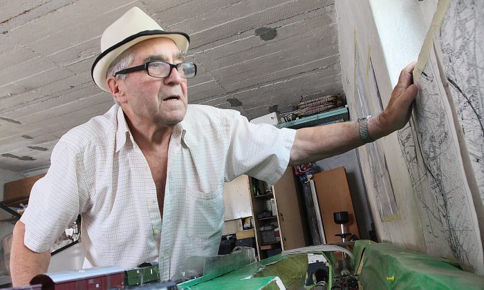 Retired miner Tadeusz Slowikowski in his garage in Walbrzych, Poland on Tuesday, Sept. 1, 2015 shows a model he made of the place where, according to him, a Nazi train, probably laden with gold and valuables, entered a mountain tunnel and was hidden as the Nazis were fleeing the Red Army in the spring of 1945. (AP Photo/Czarek Sokolowski)