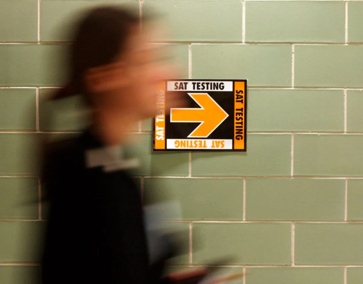 This March 12, 2005, file photo shows a student leaving after taking the SAT at Upper Arlington High School in Upper Arlington, Ohio. (AP Photo/Paul Vernon)