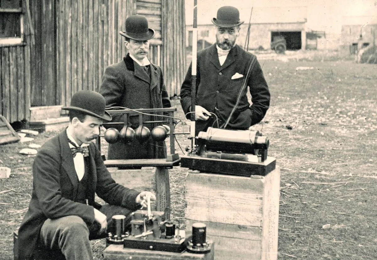British Post Office engineers inspect Guglielmo Marconi's wireless telegraphy (radio) equipment, during a demonstration on Flat Holm island, 13 May 1897. This was the world's first demonstration of the transmission of radio signals over open sea, between Lavernock Point and Flat Holm Island, a distance of 3 miles. (Council Flat Holm Project/Wikimedia Commons, CC BY
