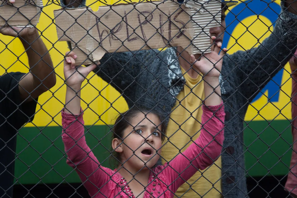 Migrants protest outside a train that they are refusing to leave for fear of being taken to a refugee camp from the train that has been held at Bicske station since yesterday on September 4, 2015 in Bicske, near Budapest, Hungary. (Matt Cardy/Getty Images)