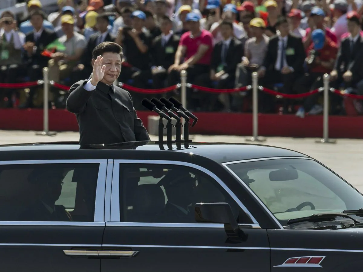 leader of the Communist Party Xi Jinping rides in an open top car as he greets soldiers and others in front of Tiananmen Square and the Forbidden City during a military parade on Sept. 3, 2015 in Beijing, China. Observers were surprised when former regime leader Jiang Zemin showed up on the reviewing stand with Xi.  (Kevin Frayer/Getty Images)