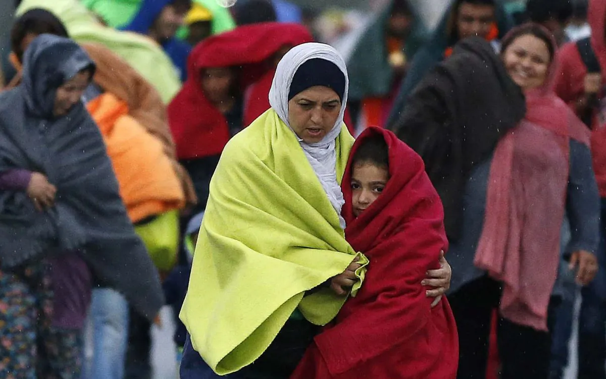 Migrants arrive at the Hungarian-Austrian border in Nickelsdorf, Austria, Saturday, Sept. 5, 2015, where they came from Budapest as Austria in the early-morning hours said it and Germany would let them in.  (AP Photo/Frank Augstein)