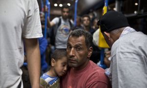 Merkel Demands EU Partners Share Burden of Migrant Influx