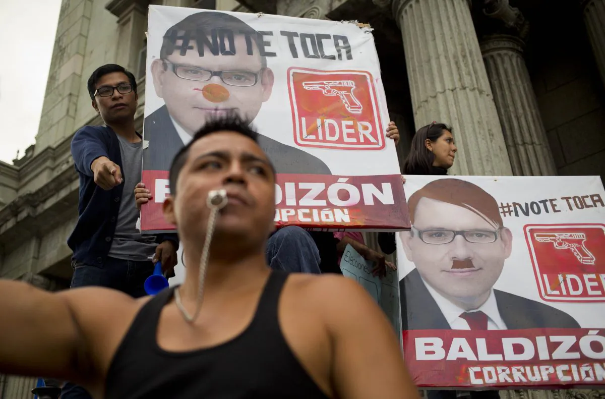 Demonstrators hold defaced campaign posters of presidential hopeful Manuel Baldizon, of the Democratic Freedom Revival Party, as they demand election reform in Guatemala City, Saturday, Sept. 5, 2015, the day before general elections. Voters will go to the polls Sunday for normally scheduled general elections less than a week after Otto Perez Molina resigned as president. The signs read in Spanish: "It's not your turn," top left, and "Corrupt."  (AP Photo/Moises Castillo)