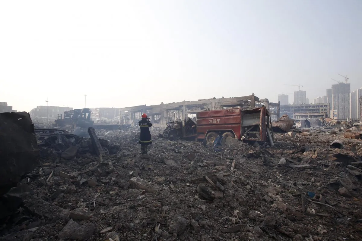 A firefighter is seen recording the aftermath at the site of the explosions in Tianjin on August 15, 2015. (STR/AFP/Getty Images)