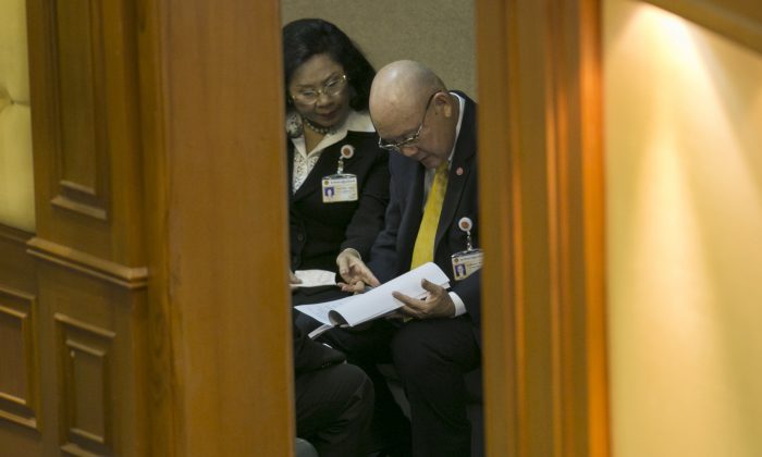 Thienchai Kiranan, right, president of Thailand's legislature, known as the National Reform Council, looks over notes before the start of the session before the body voted on the new draft constitution Sunday, Sept. 6, 2015, in Bangkok, Thailand.  (AP Photo/Wason Wanichakorn)