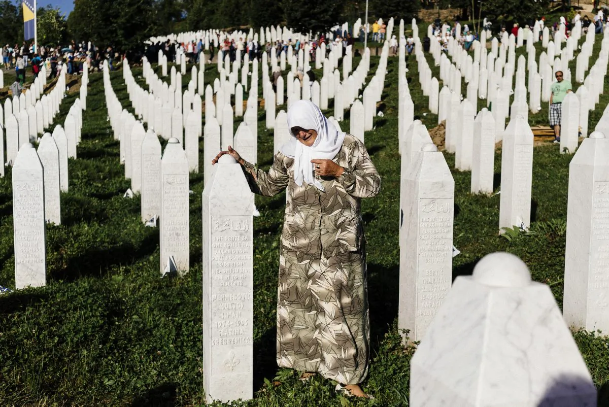 A Bosnian woman mourns at the grave of a relative on July 11, 2015, at the Potocari Memorial Center near the Bosnian Town of Srebrenica, where 136 bodies found in mass grave sites in eastern Bosnia were properly reburied on the 20th anniversary of the Srebrenica Massacre. (Dimitar Dilkoff/AFP/Getty Images)