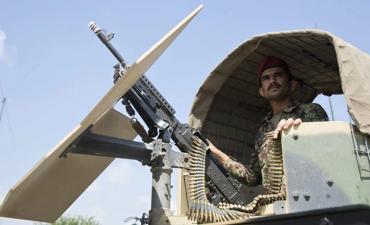 FILE - In this Wednesday, Aug. 5, 2015 file photo, an Afghanistan's National Army soldier stands guard in his vehicle in Camp Khogyani in Nangarhar province, east of Kabul, Afghanistan. Homegrown militants loyal to the Islamic State group are making inroads into Afghanistan, controlling territory in some parts of the country and ruling with the harsh hand the group is notorious for in Iraq and Syria, according to officials, military leaders and analysts. (AP Photo/Massoud Hossaini, File)